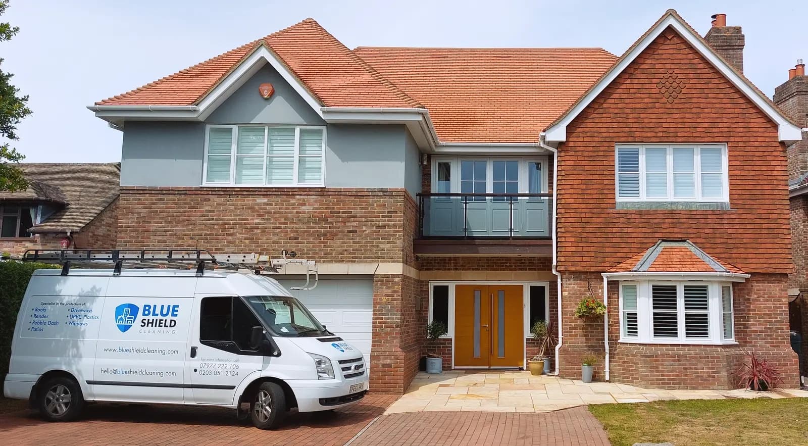 A Blue Shield van parked in front of a freshly cleaned detached house
